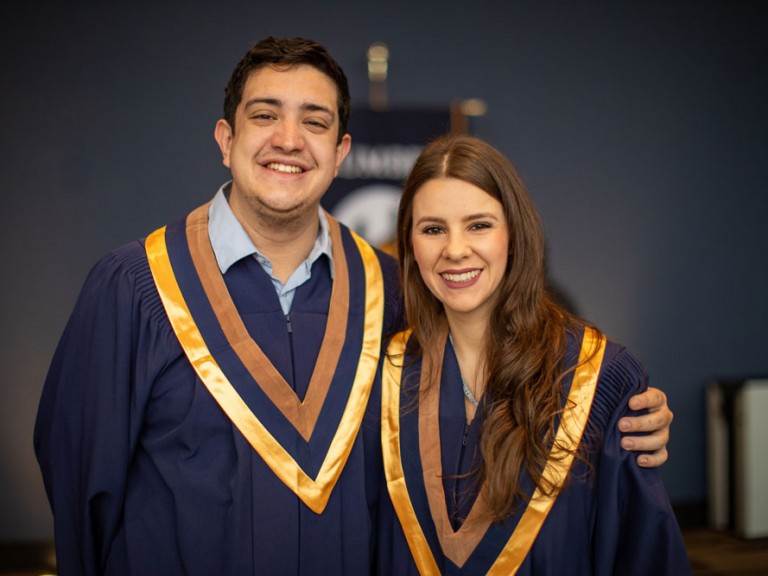 Two grads smiling for photo