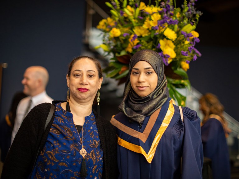 Grad posing with their mother