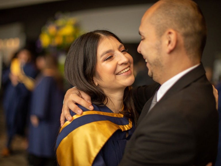 Grad hugging person