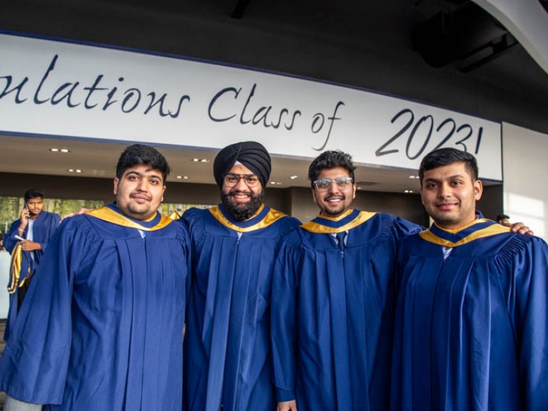 Four graduates posing for photo