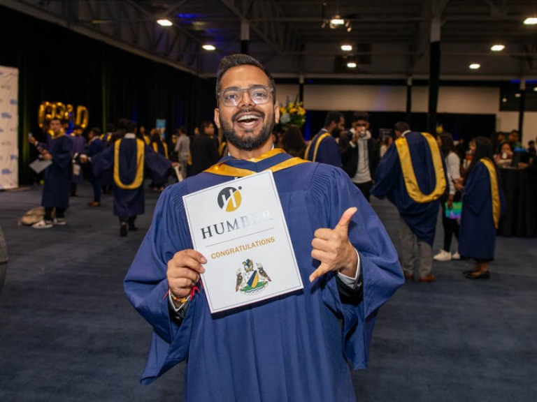 Graduate smiles for photo