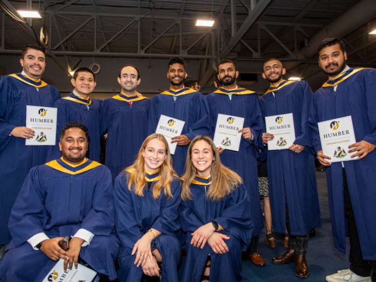 Ten graduates pose for photo
