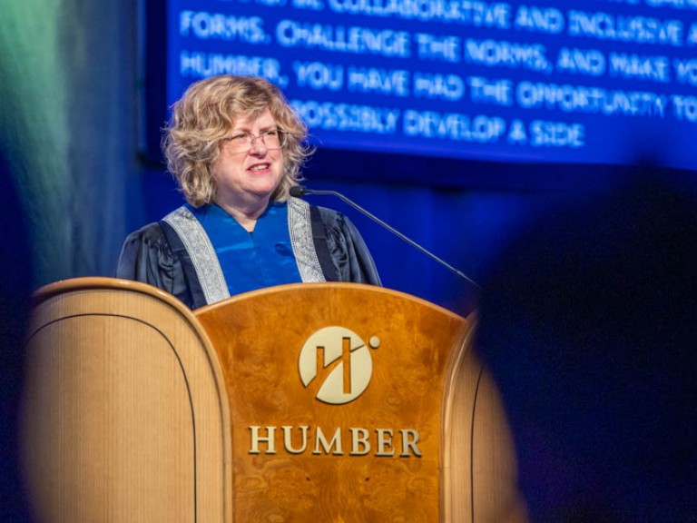 Humber president Ann Marie Vaughan speaking into podium microphone