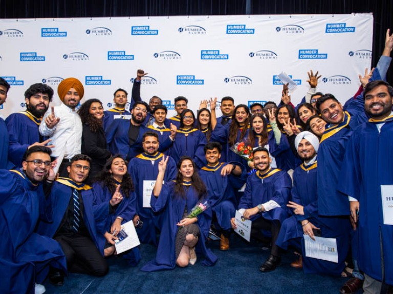 Large group of graduates show excitement for camera