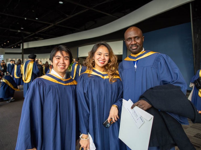 Three graduates posing for photo