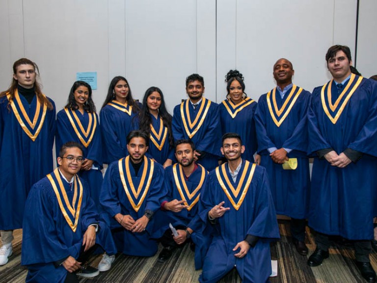Twelve graduates pose for photo