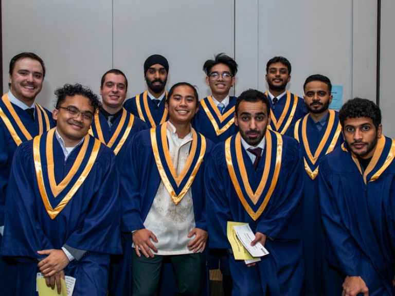 Ten graduates pose for photo