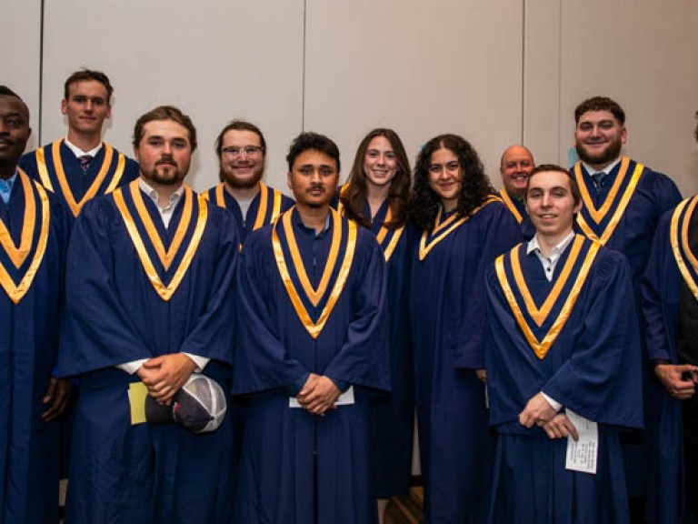 Eleven graduates stand for photo