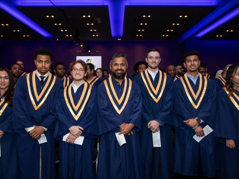 Row of graduates with hands