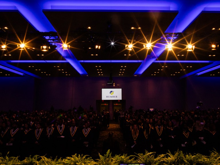 View of graduates seated in audience from the stage