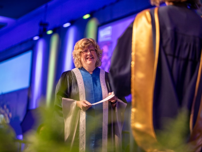 Ann Marie Vaughan presents certificate on stage