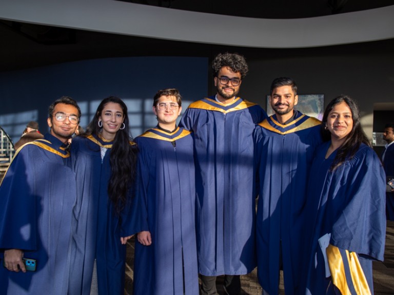 Six graduates posing for photo