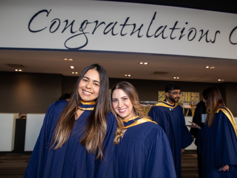 Two graduates take photo together