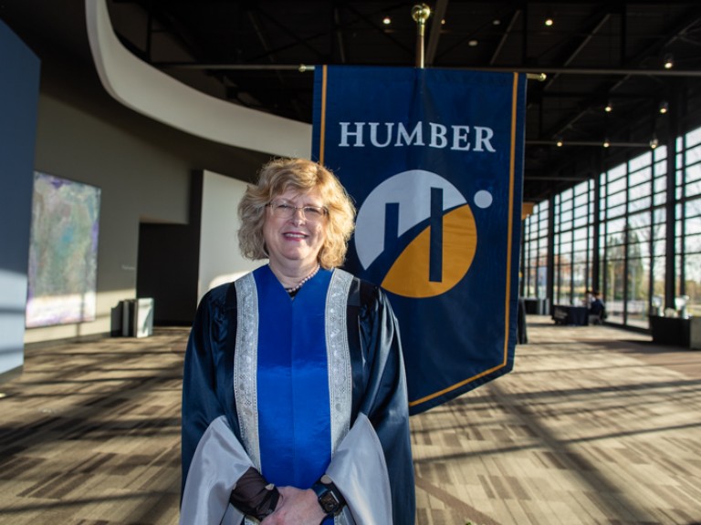 Ann Marie Vaughan poses in front of Humber flag