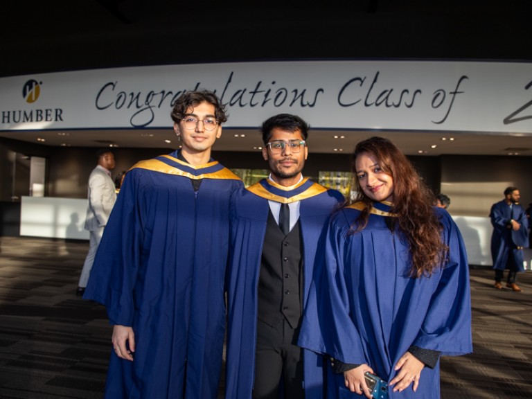 Three graduates posing for photo