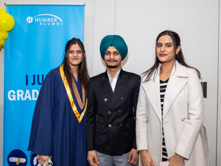 Graduate takes photo with two guests