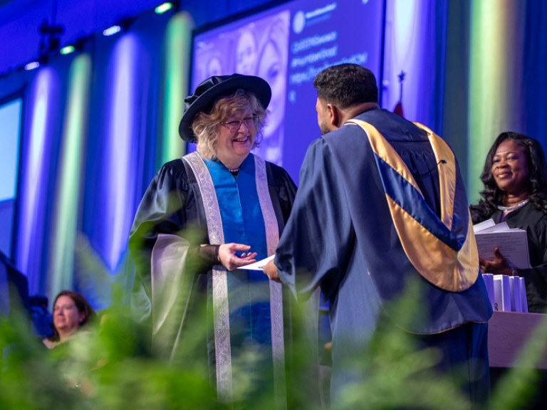 Ann Marie Vaughan giving certificate to graduate