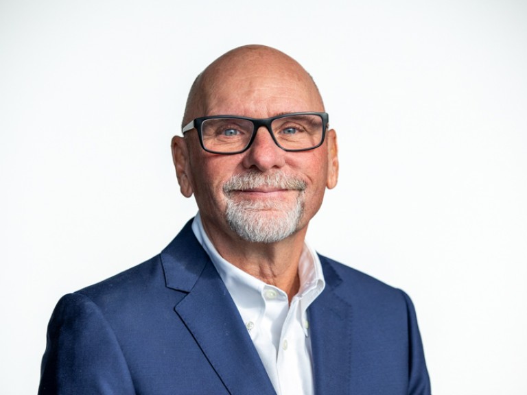 Person smiling against a white background