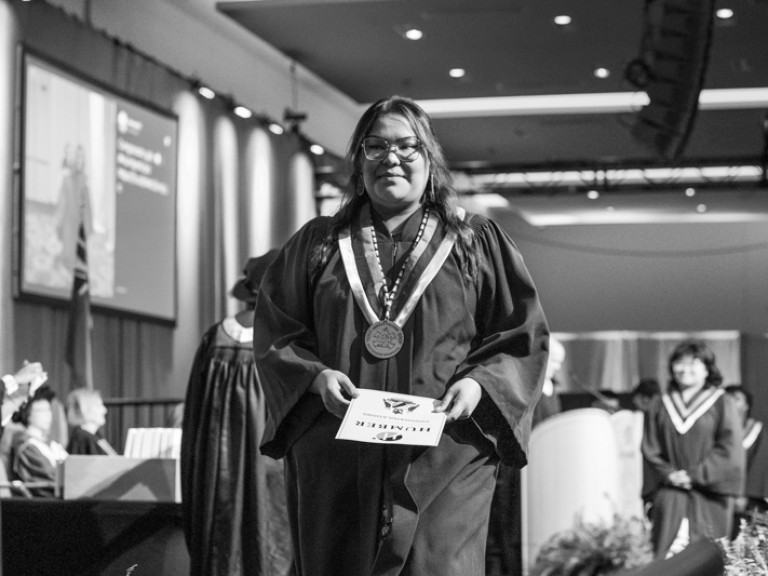 Person with Indigenous graduate necklace walks off stage