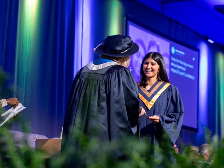 Graduate accepts certificate on stage