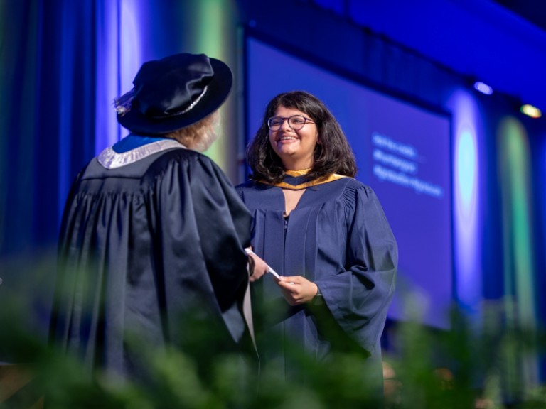 Graduate accepts certificate on stage