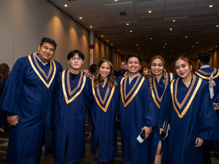 Six graduates take photo together