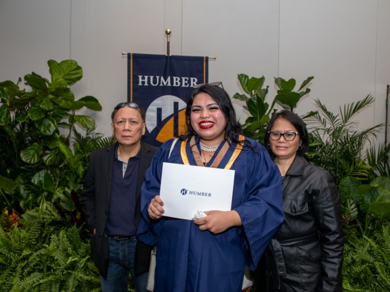 Graduate takes photo with parents