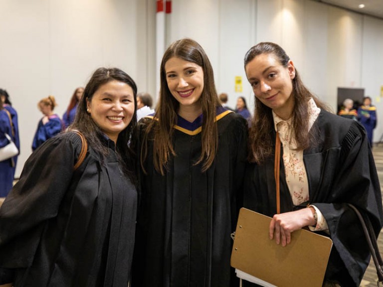 Three people smiling for photo