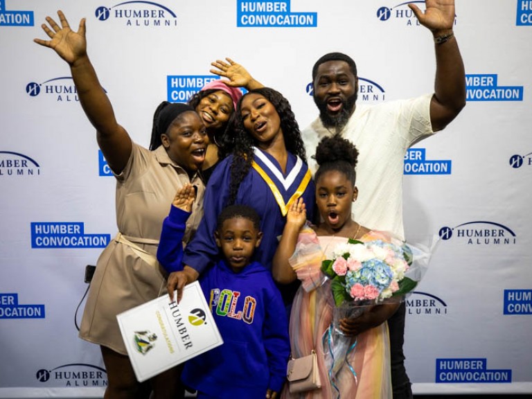 Graduate taking photo with their family