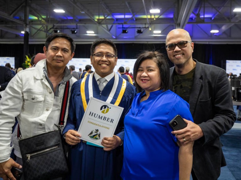 Graduate taking photo with family