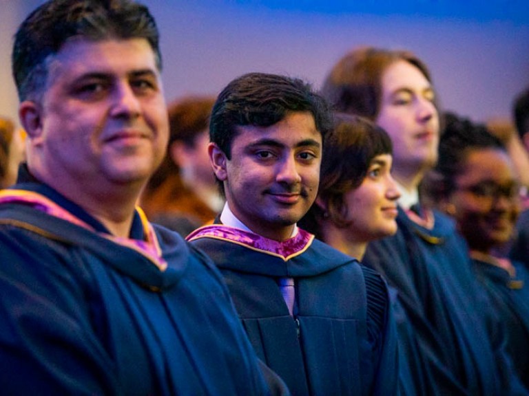 Graduates looking at camera