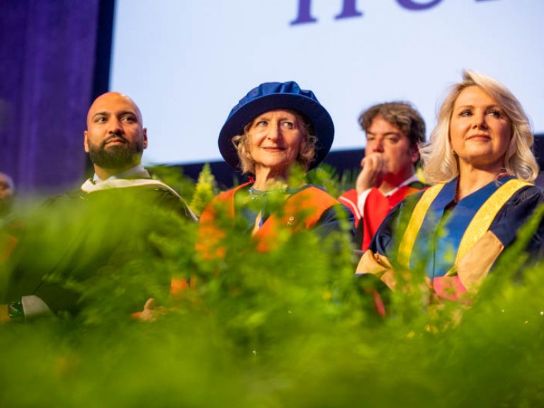 People seated on stage looking to the right