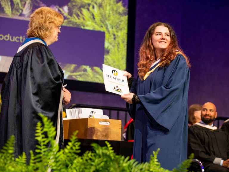 Graduate accepting certificate on stage