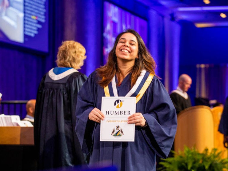 Graduate smiling holding certificate