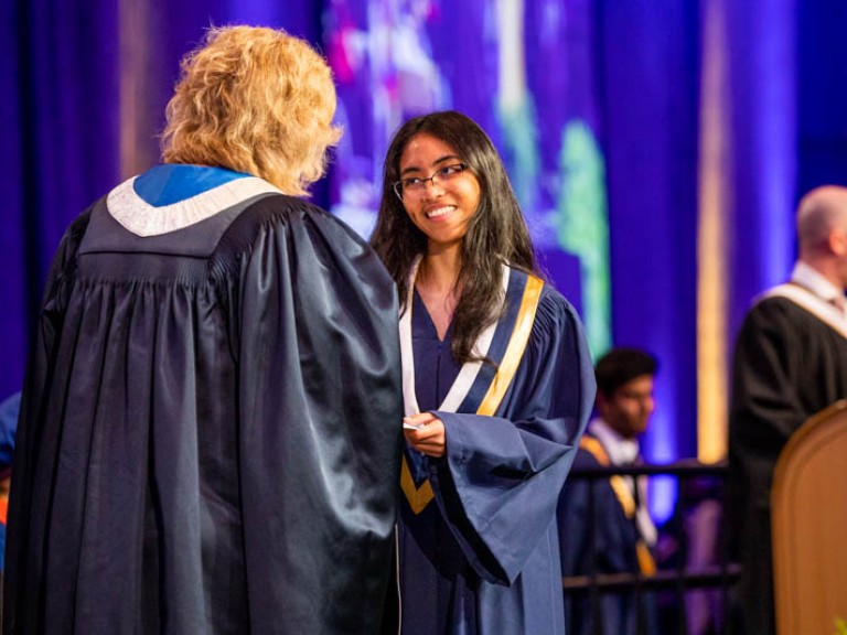 Graduate accepting certificate from Humber president