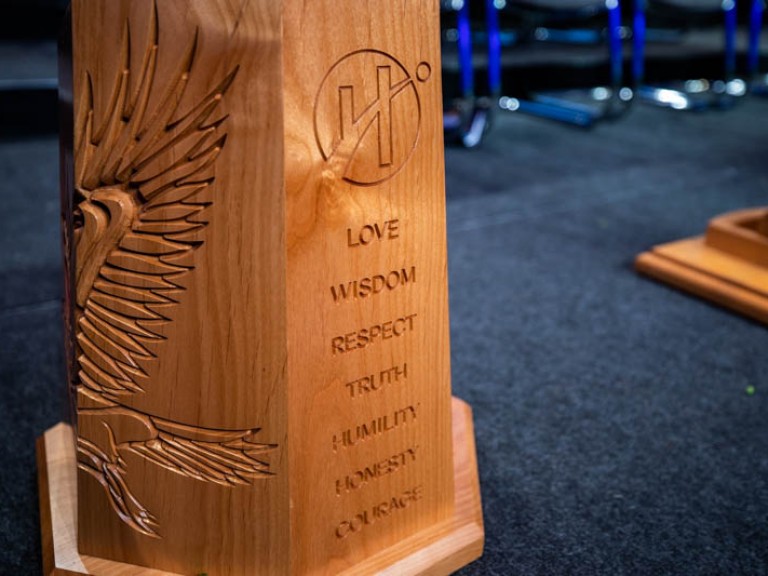 Carved podium with Humber logo with words underneath it: Love, Wisdom, Respect, Truth, Humility, Honesty, Courage