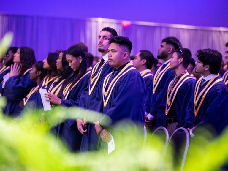 Graduates standing in the audience