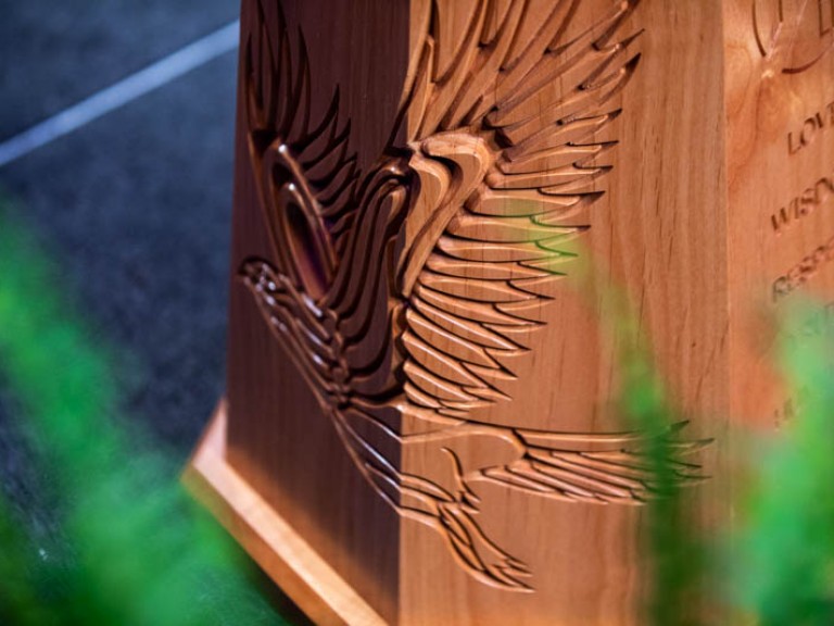 Closeup of bird design carved into podium