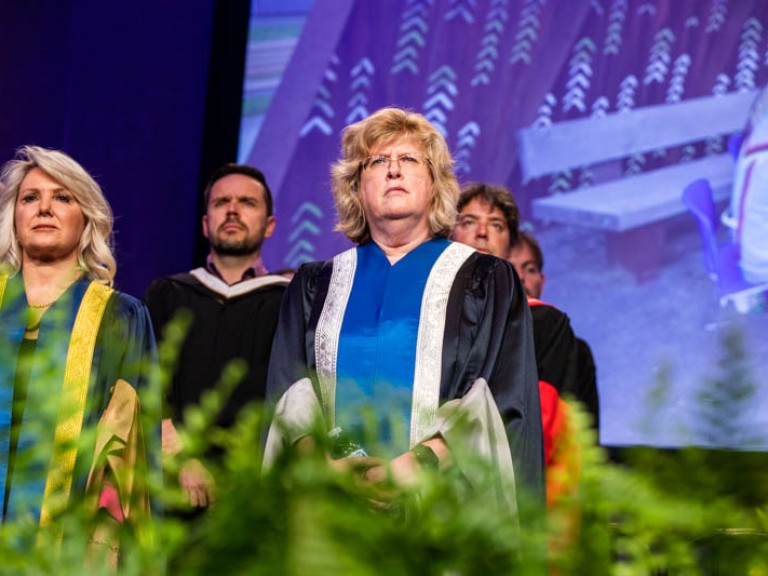Ann Marie Vaughan and other faculty standing on stage