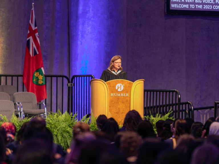 Person speaking on stage at podium