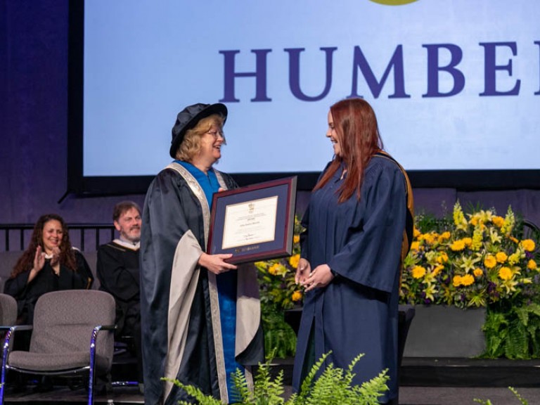 Ann Marie Vaughan presents award to graduate