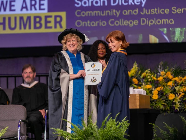 Humber president and graduate holding certificate