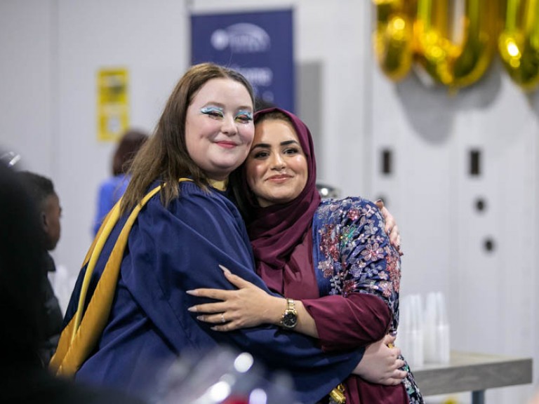 Graduate hugging ceremony guest