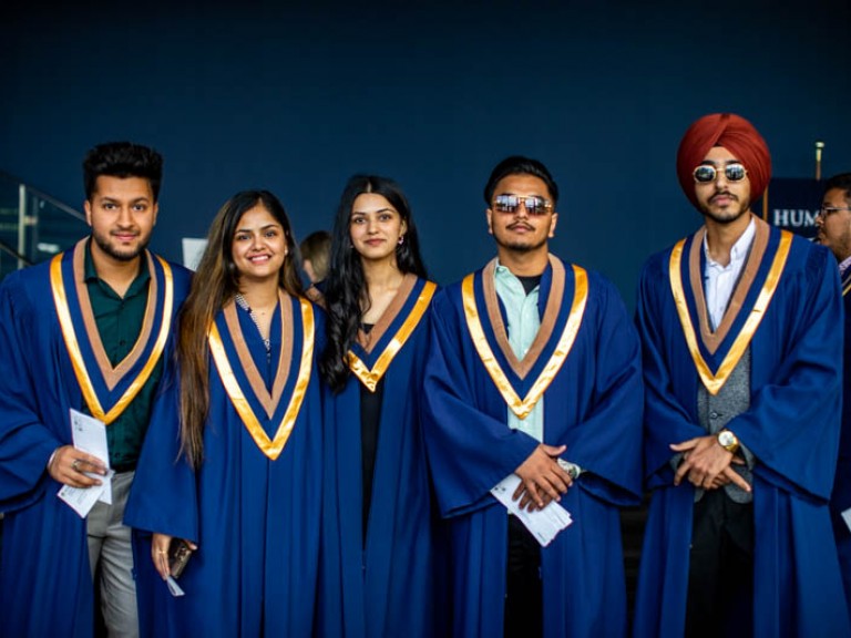 Five graduates pose for photo