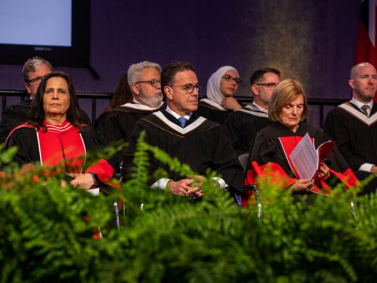 Humber faculty members and honorary degree recipient seated on stage