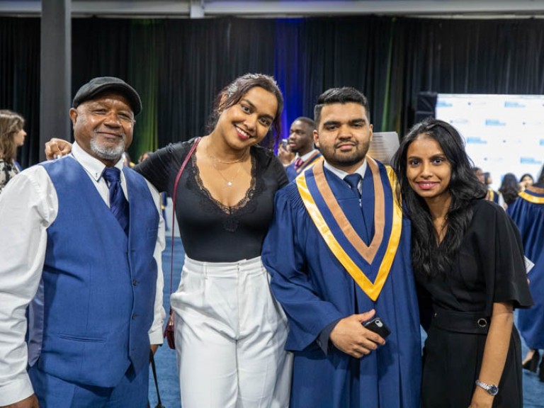 Graduate poses with family