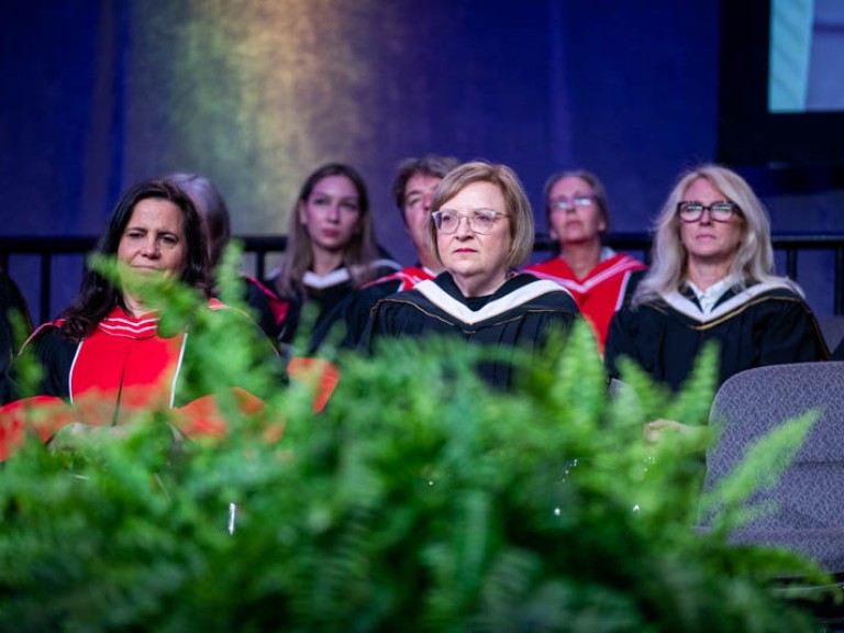 Honorary degree recipient Lana Payne seated on stage