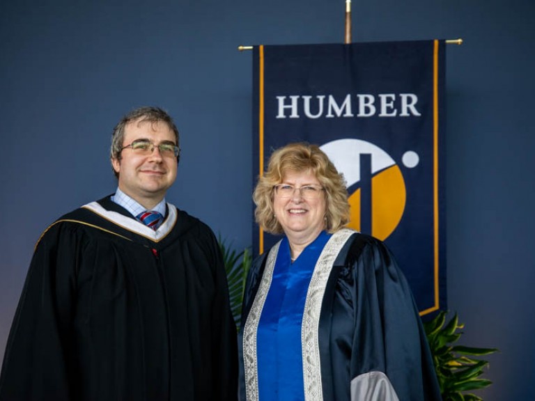 Andrew Monkhouse poses for photo with Humber president Ann Marie Vaughan