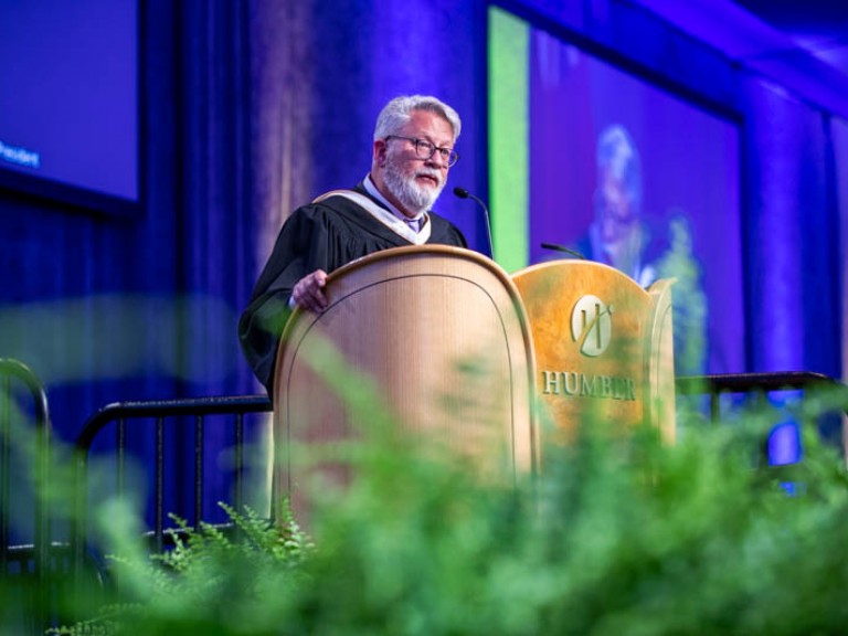 Person standing behind Humber podium