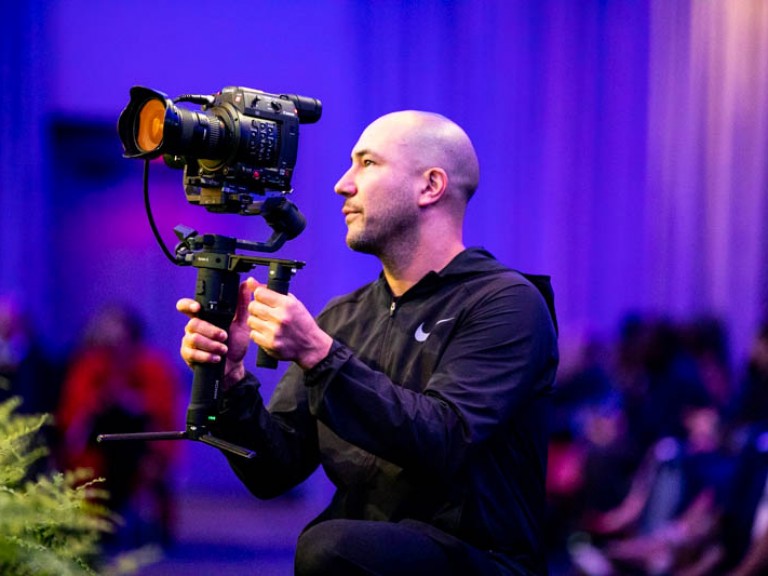 Photographer kneeling holding camera